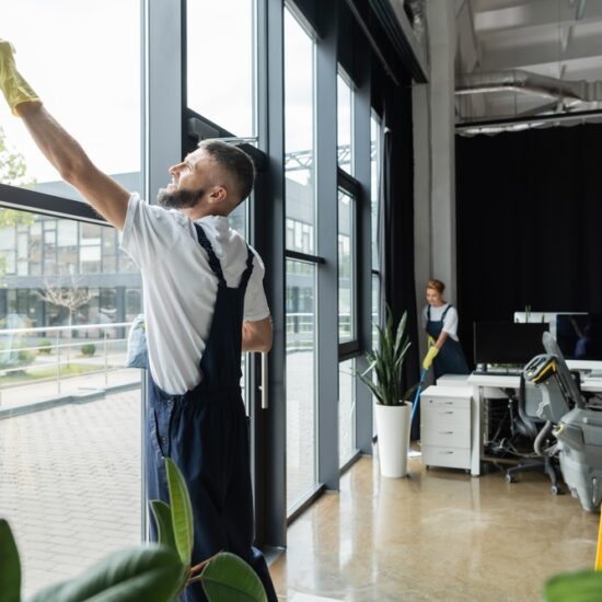 Bearded,Man,Washing,Office,Windows,Near,Interracial,Women,Working,On